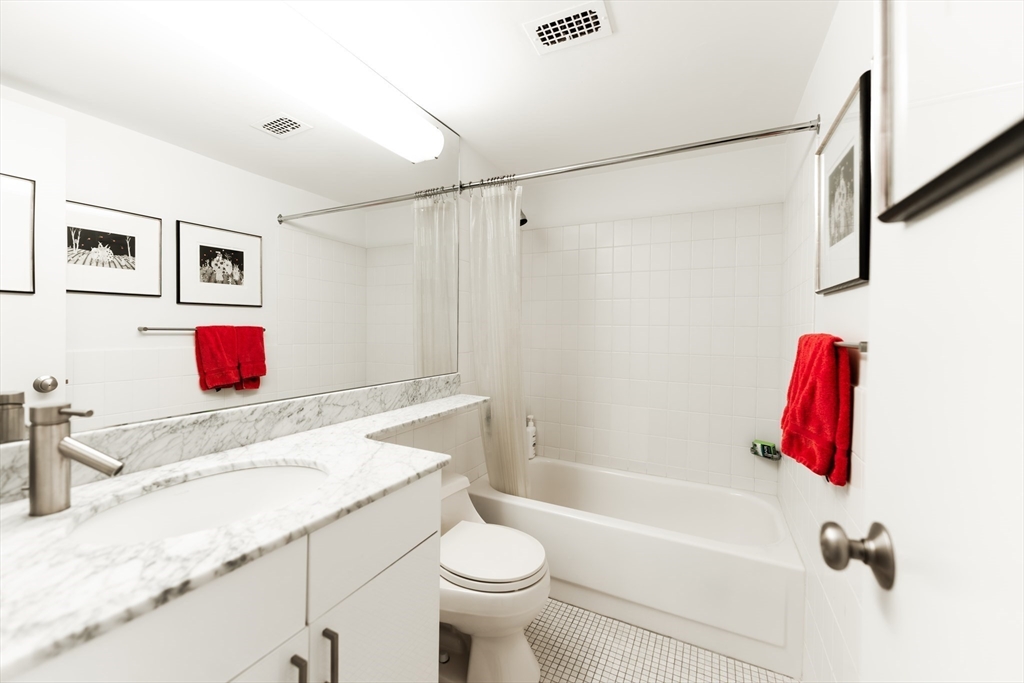 1010 Memorial Drive, Unit 6G Cambridge, MA 02138 - Photo 15 of 22 a bathroom with a sink vanity mirror and toilet