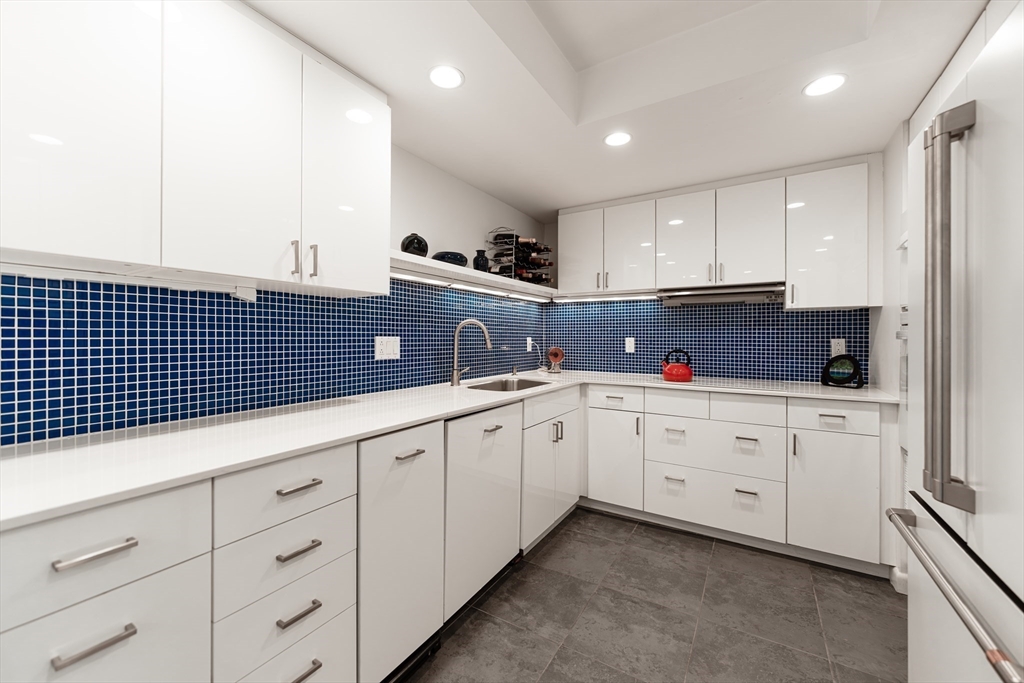1010 Memorial Drive, Unit 6G Cambridge, MA 02138 - Photo 17 of 22 a kitchen with granite countertop white cabinets and sink
