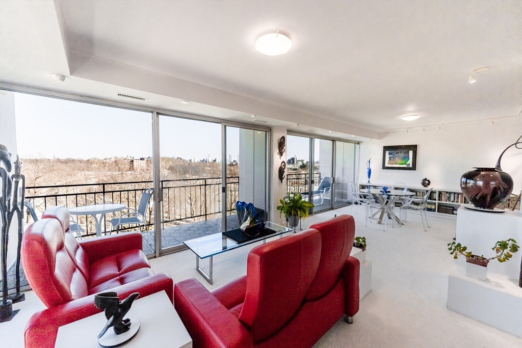 1010 Memorial Drive, Unit 6G Cambridge, MA 02138 - Photo 7 of 22 a living room with furniture and floor to ceiling windows