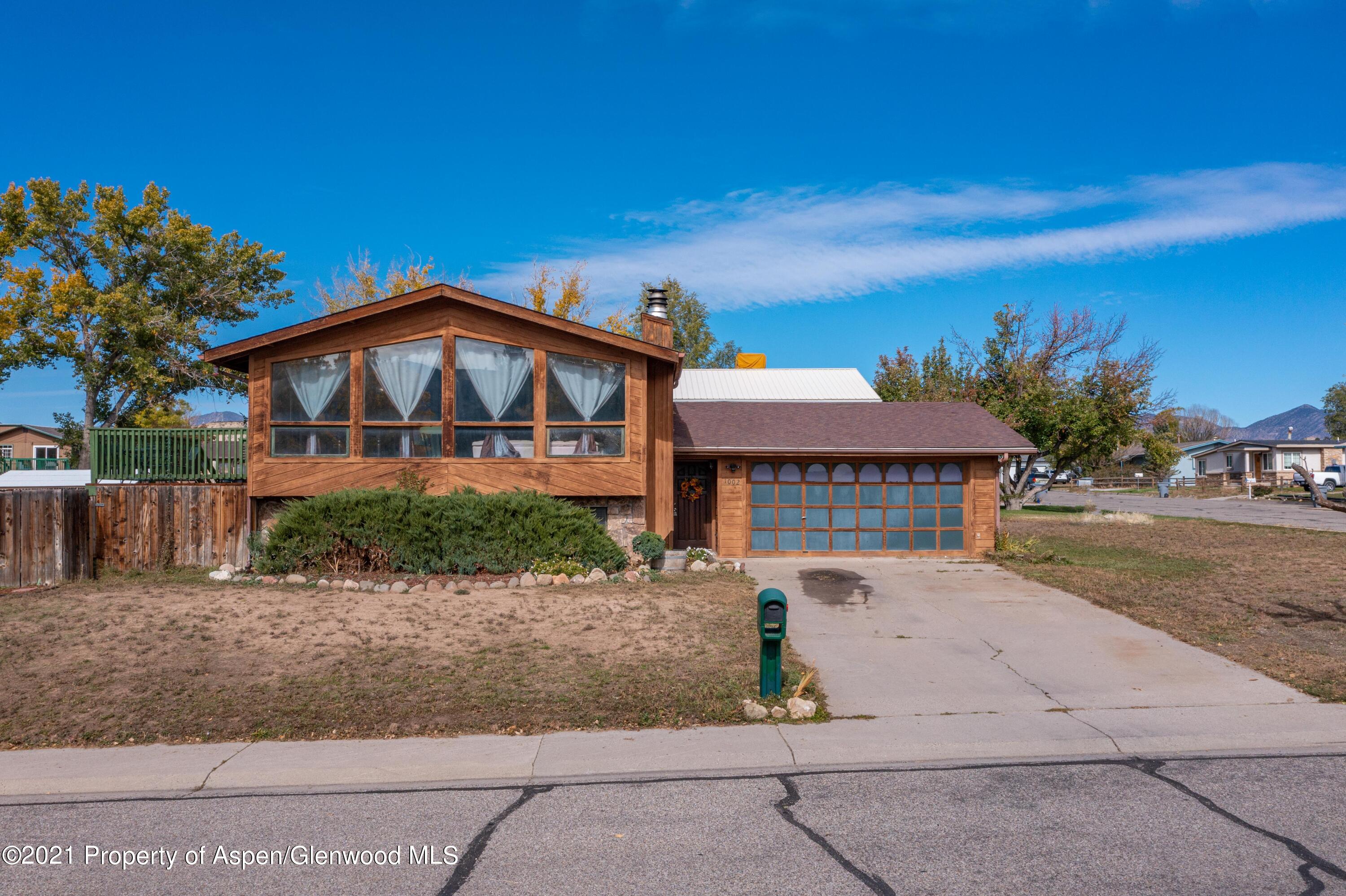 1002 Arnold Court Rifle, CO 81650 - Photo 1 of 15 a front view of a house with a yard