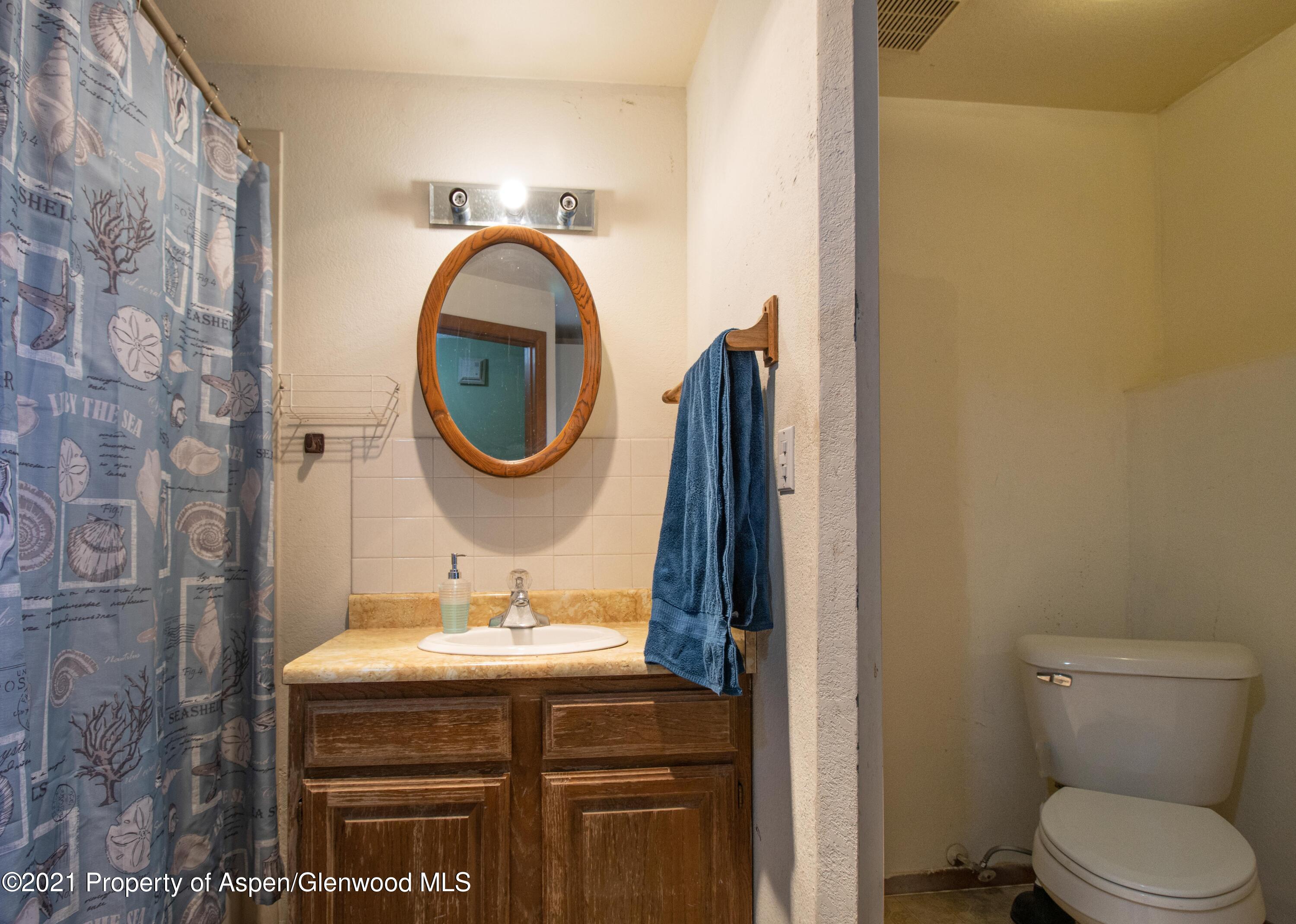 1002 Arnold Court Rifle, CO 81650 - Photo 12 of 15 a bathroom with a sink and a mirror