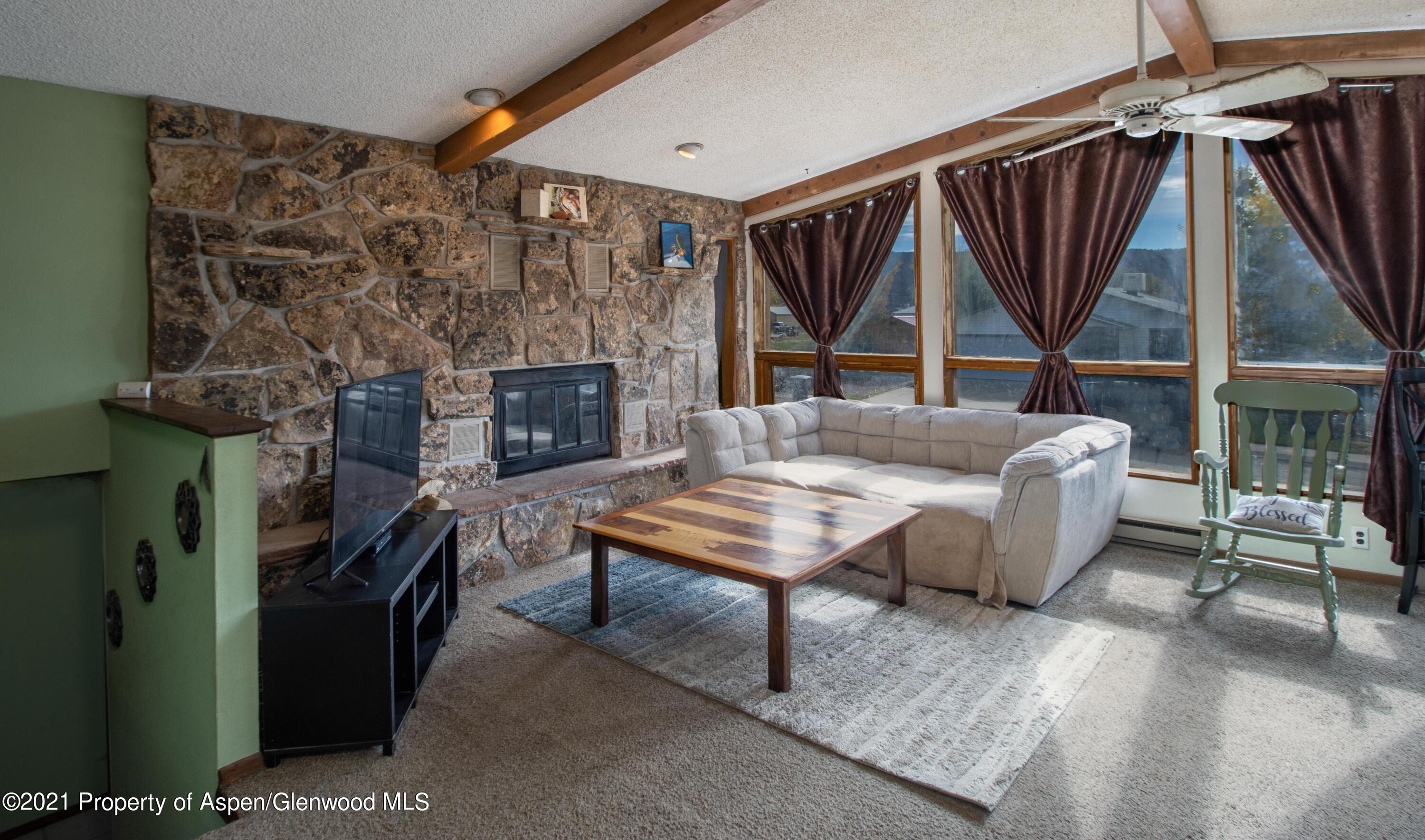 1002 Arnold Court Rifle, CO 81650 - Photo 6 of 15 a living room with furniture a flat screen tv and a fireplace