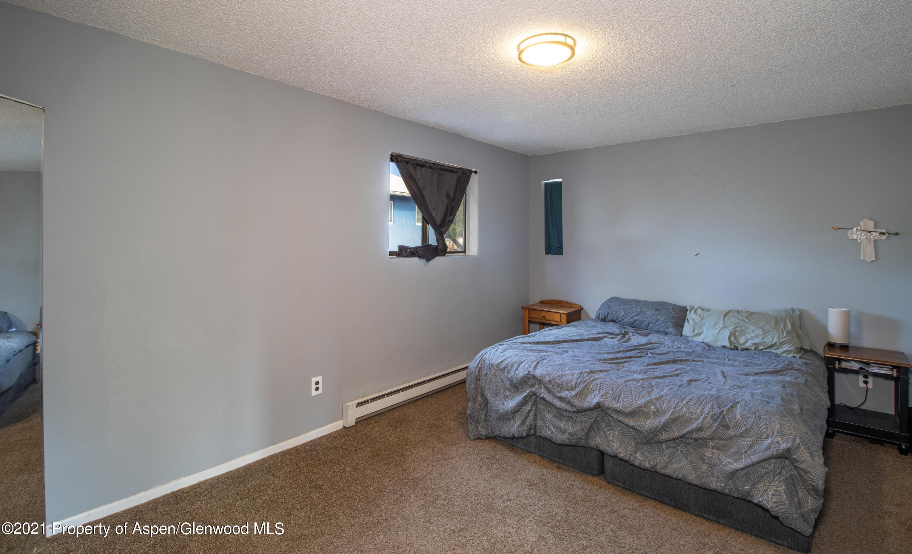 1002 Arnold Court Rifle, CO 81650 - Photo 7 of 15 a bedroom with a bed and a window