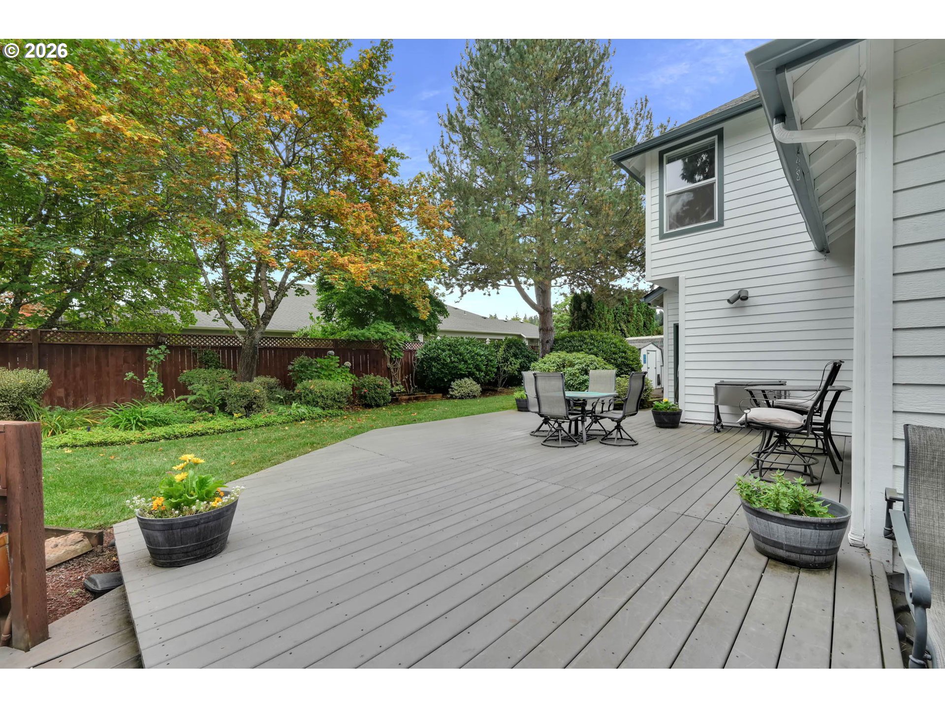 3379 South Lambert Street Eugene, OR 97405 - Photo 35 of 44 a view of a patio with table and chairs potted plants and a large tree