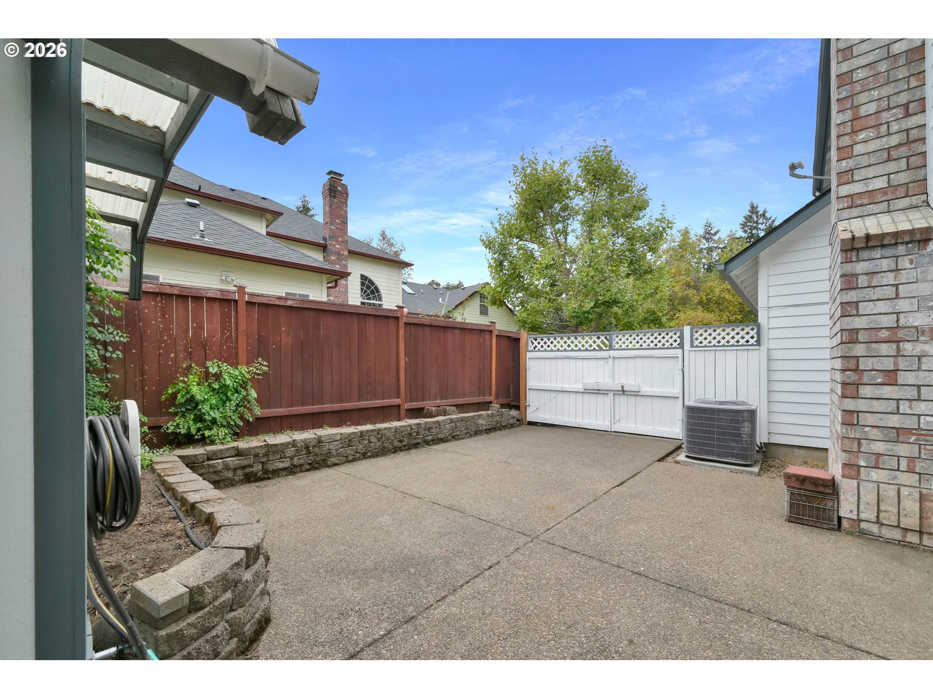 3379 South Lambert Street Eugene, OR 97405 - Photo 41 of 44 a view of backyard with potted plants and wooden fence