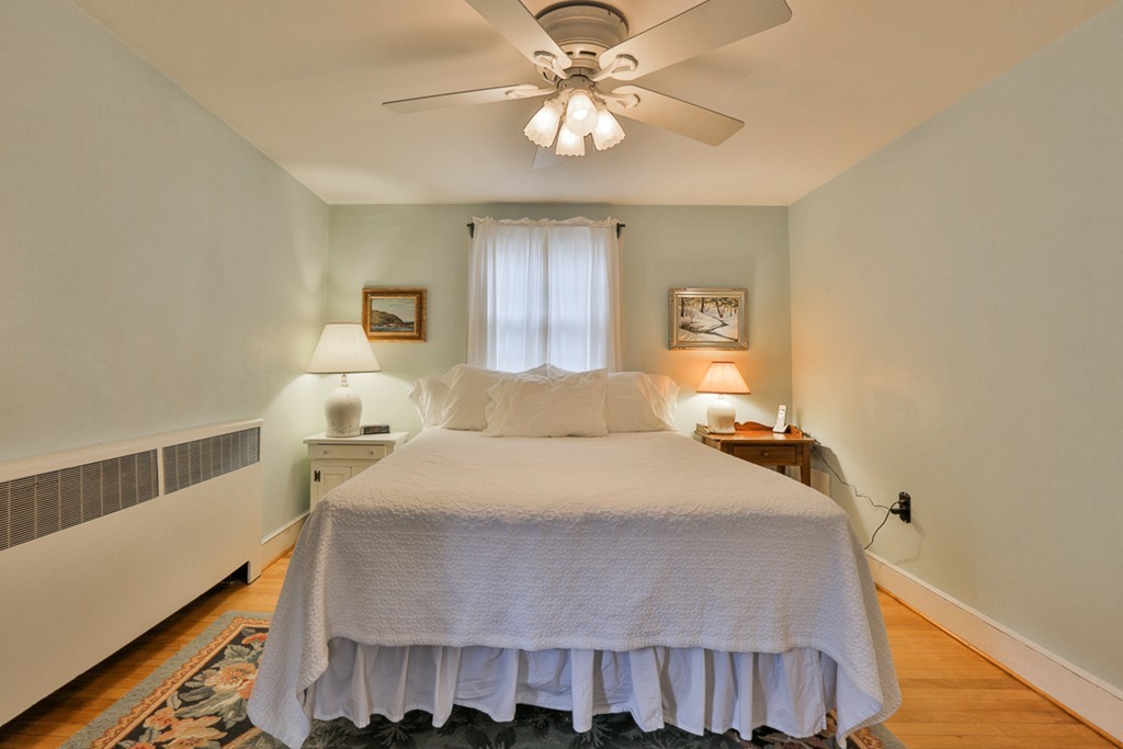 31 Depot Road Boxford, MA 01921 - Photo 20 of 30 a bedroom with a bed and a chandelier
