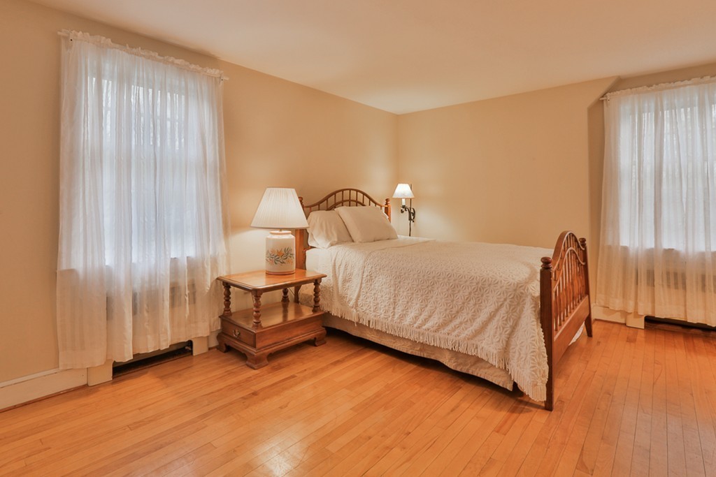 31 Depot Road Boxford, MA 01921 - Photo 21 of 30 a bedroom with a bed and wooden floor