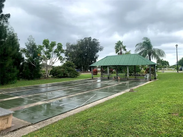 a view of patio with table and chairs under an umbrella