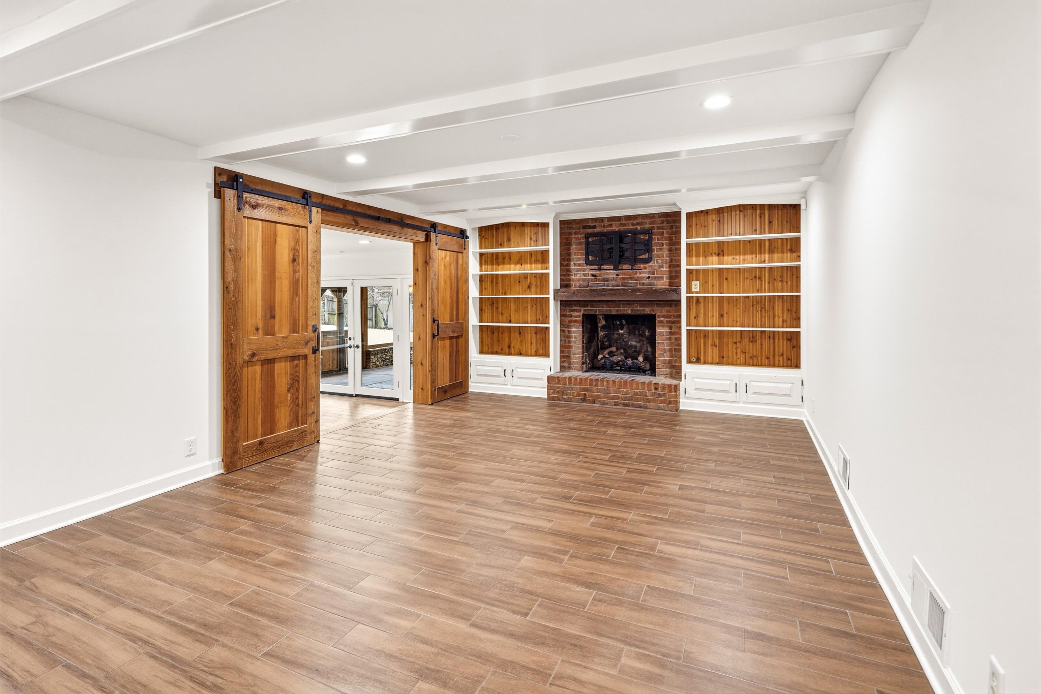 2115 Brierbrook Road Memphis, TN 38138 - Photo 13 of 40 a view of an empty room with wooden floor and a window