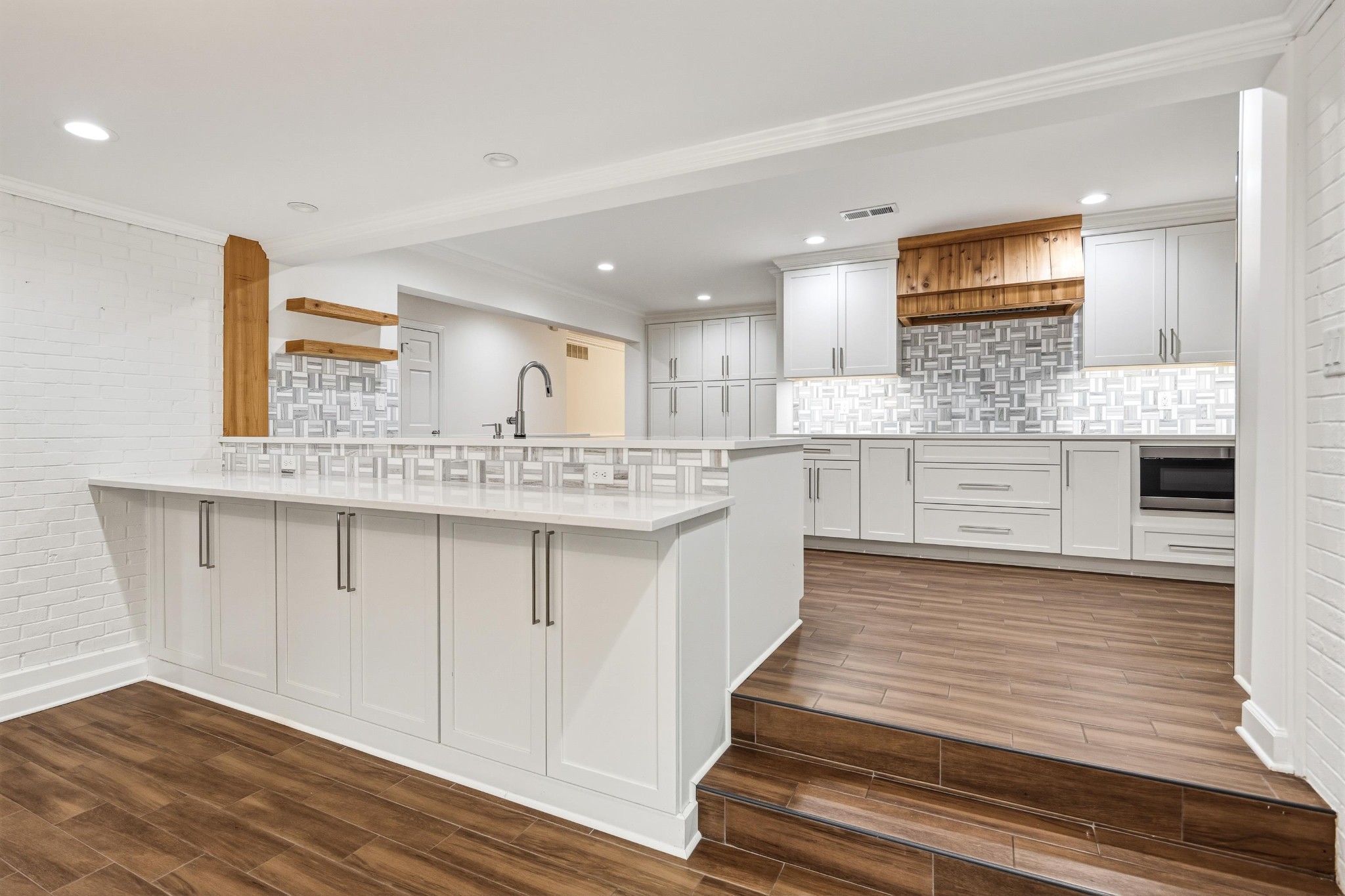 2115 Brierbrook Road Memphis, TN 38138 - Photo 17 of 40 a large white kitchen with kitchen island a sink stainless steel appliances and cabinets