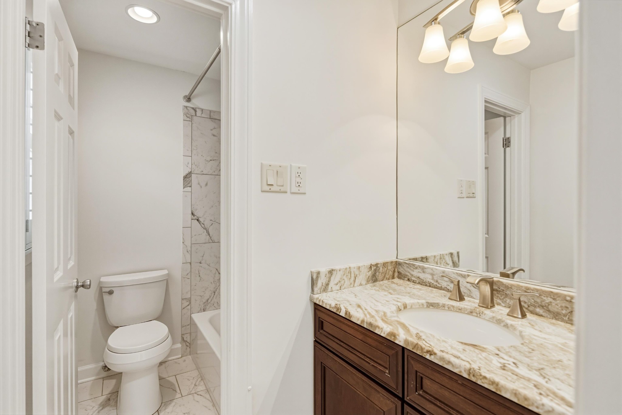 2115 Brierbrook Road Memphis, TN 38138 - Photo 27 of 40 a bathroom with a granite countertop sink a toilet and a mirror