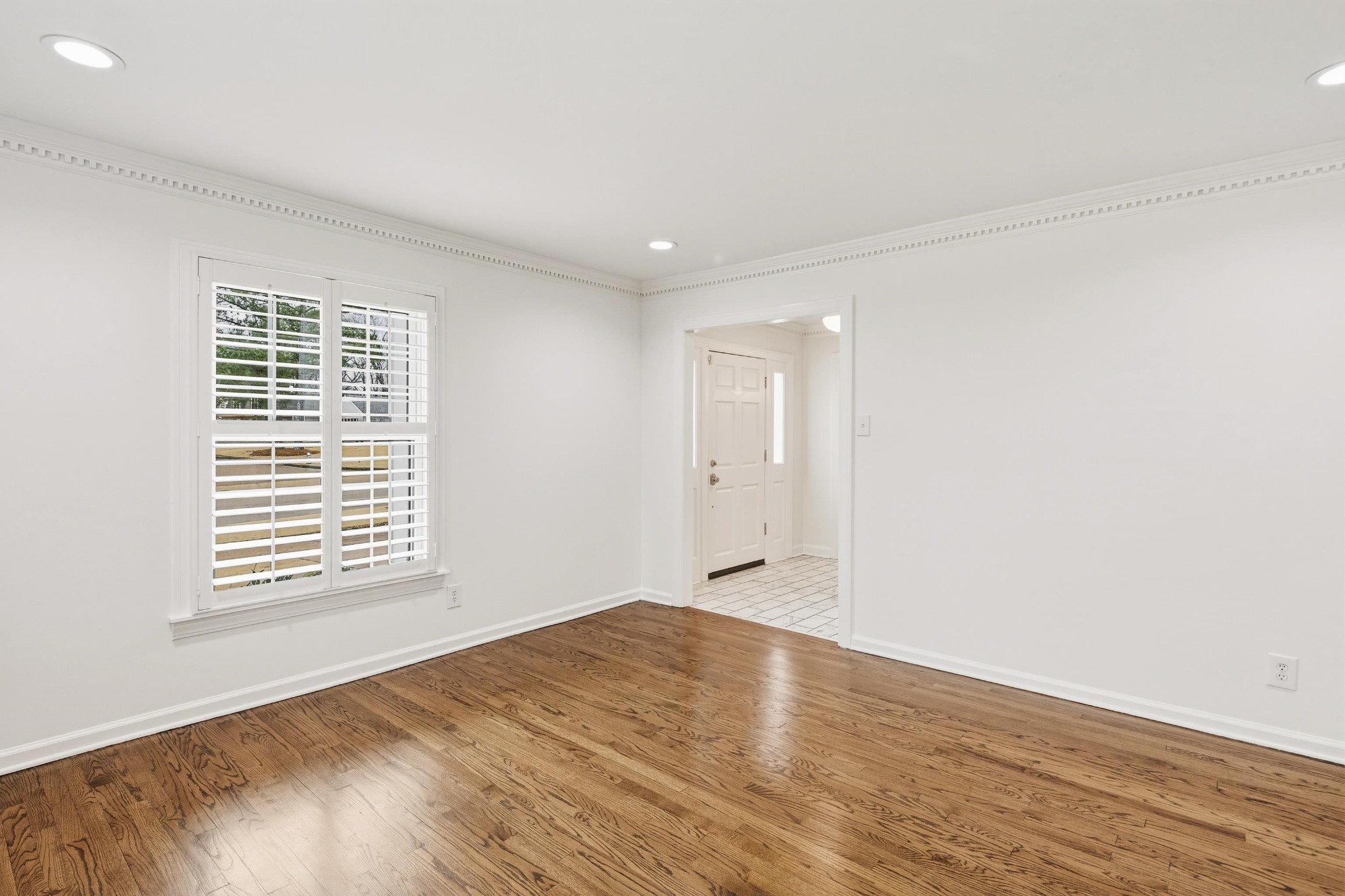 2115 Brierbrook Road Memphis, TN 38138 - Photo 6 of 40 a view of an empty room with wooden floor and a window