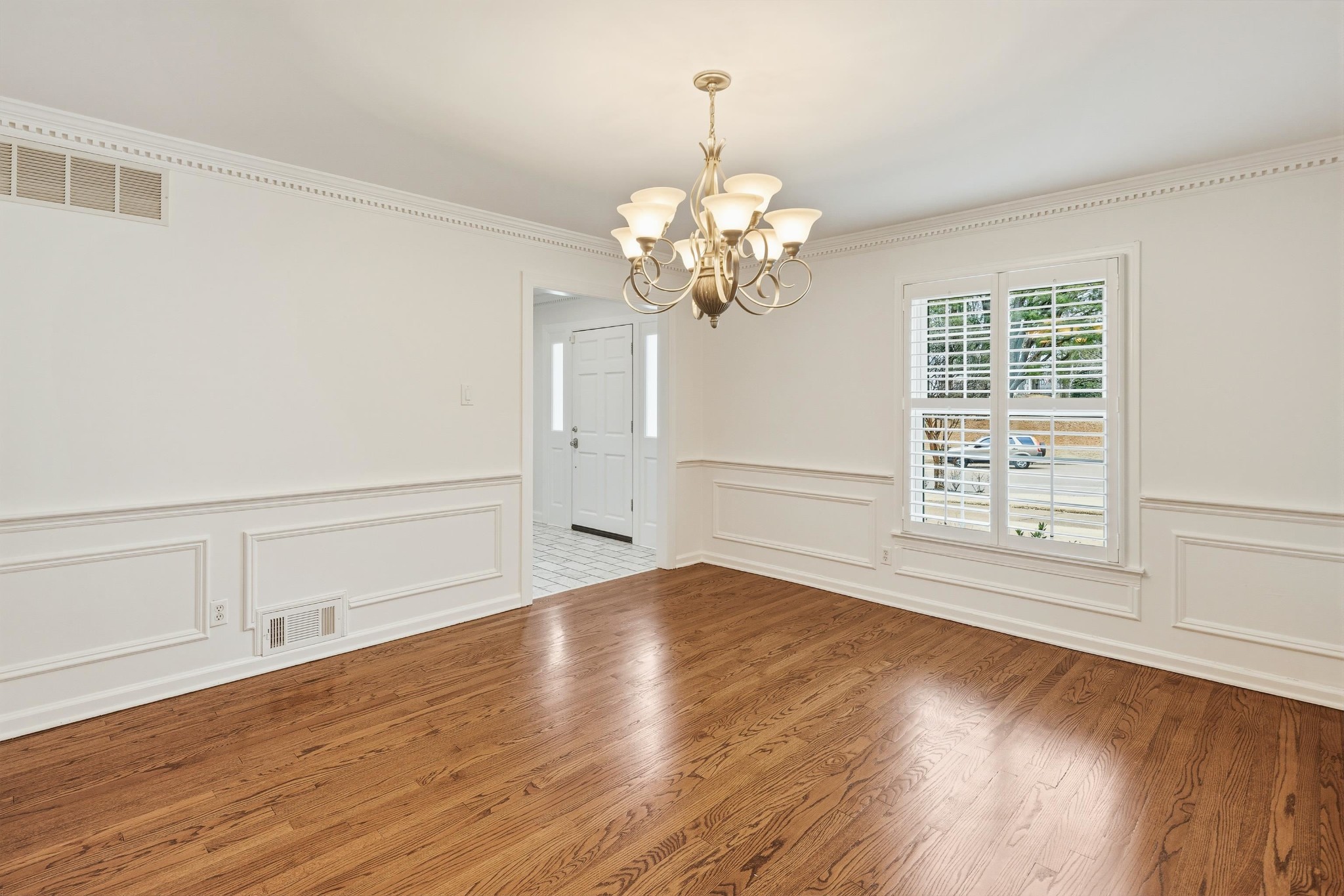 2115 Brierbrook Road Memphis, TN 38138 - Photo 9 of 40 a view of an empty room with wooden floor and a window
