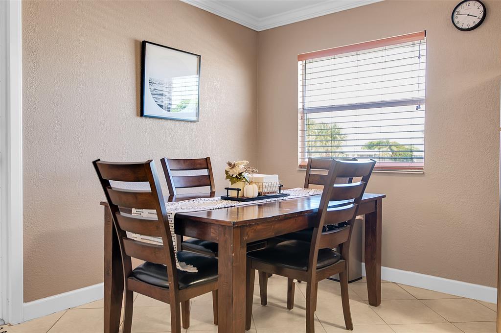 409 Brittany Drive, Unit 409 Delray Beach, FL 33446 - Photo 14 of 41 a dining room with furniture and window