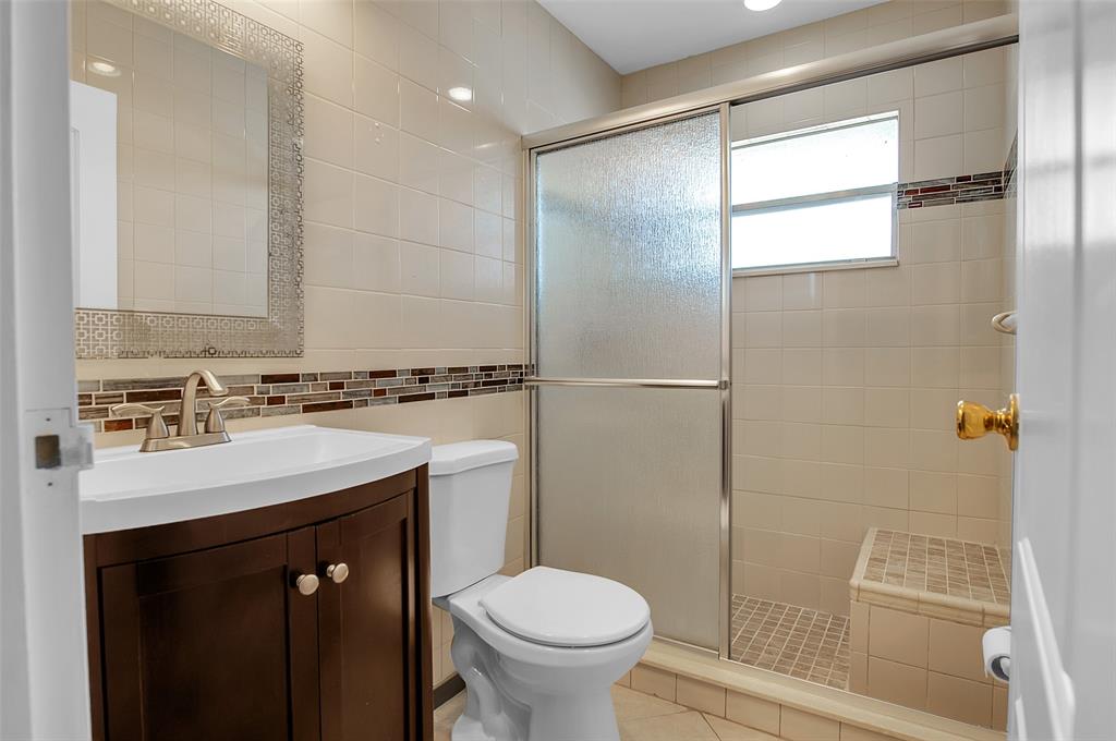 409 Brittany Drive, Unit 409 Delray Beach, FL 33446 - Photo 21 of 41 a bathroom with a sink toilet and shower