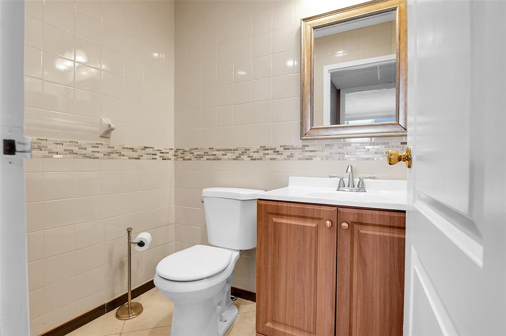 409 Brittany Drive, Unit 409 Delray Beach, FL 33446 - Photo 31 of 41 a bathroom with a sink a toilet and shower
