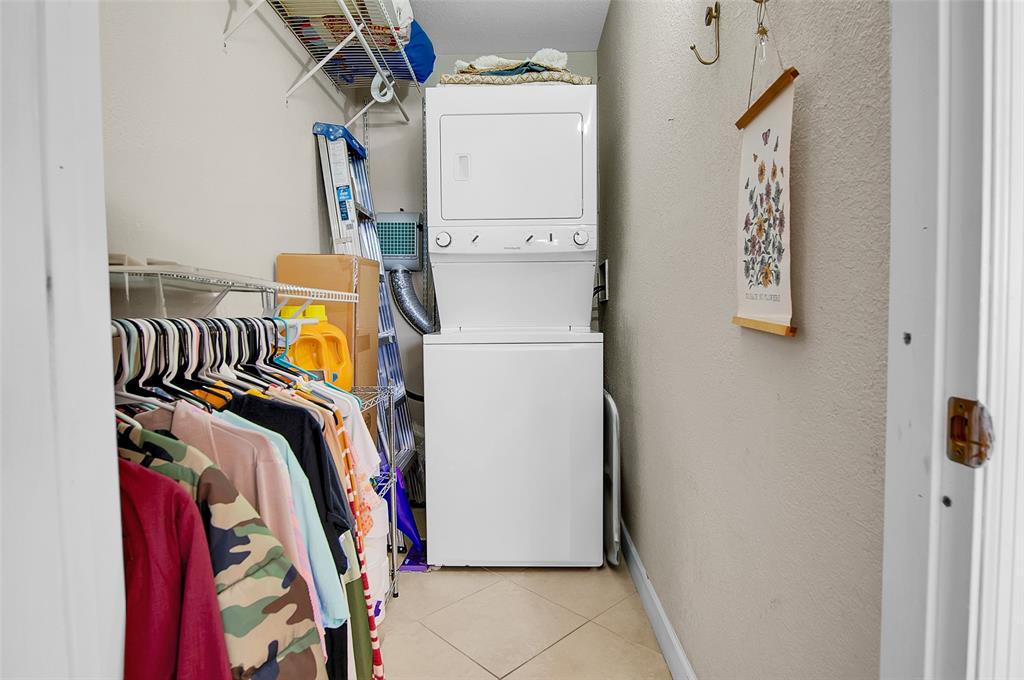 409 Brittany Drive, Unit 409 Delray Beach, FL 33446 - Photo 33 of 41 a view of walk in closet with clothes and shoes
