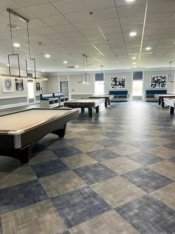 a lobby with furniture and a flat screen tv