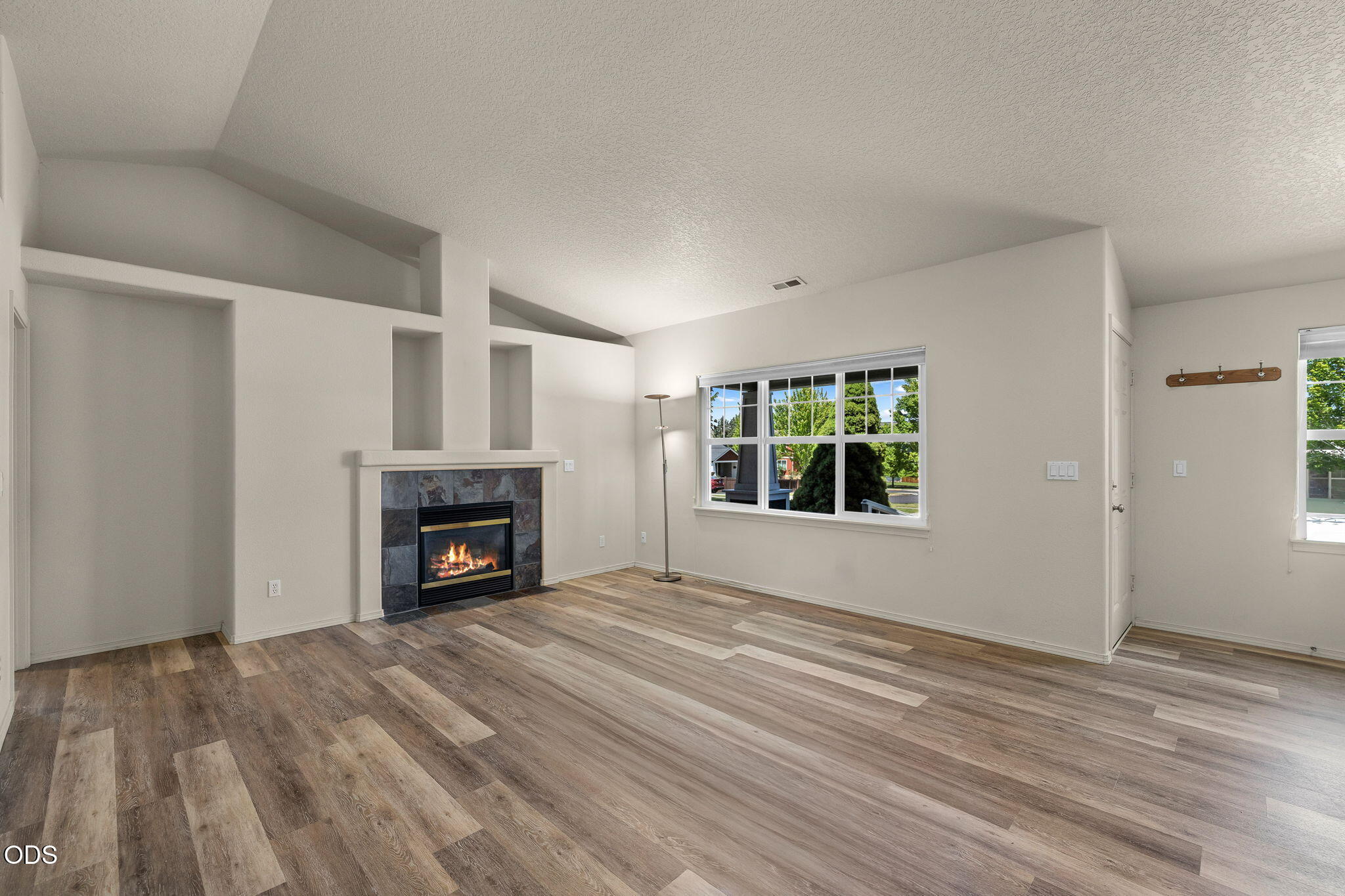 20535 Sunderland Way Bend, OR 97701 - Photo 15 of 41 a view of empty room with a fireplace and window