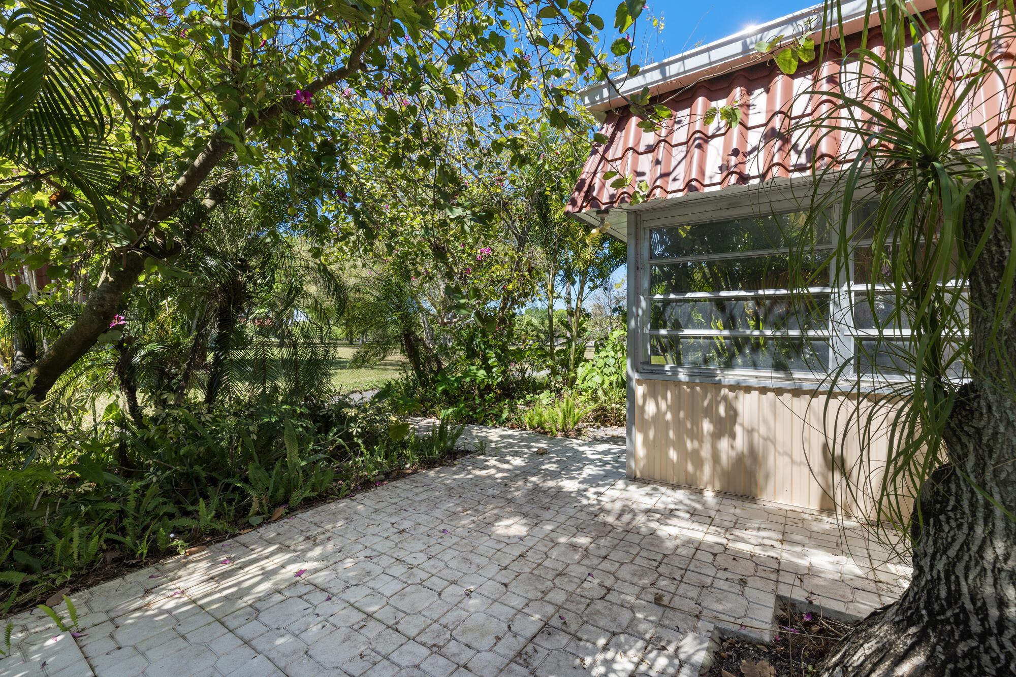 251 Down E Lane Lake Worth, FL 33467 - Photo 17 of 22 a pathway of a house with a yard