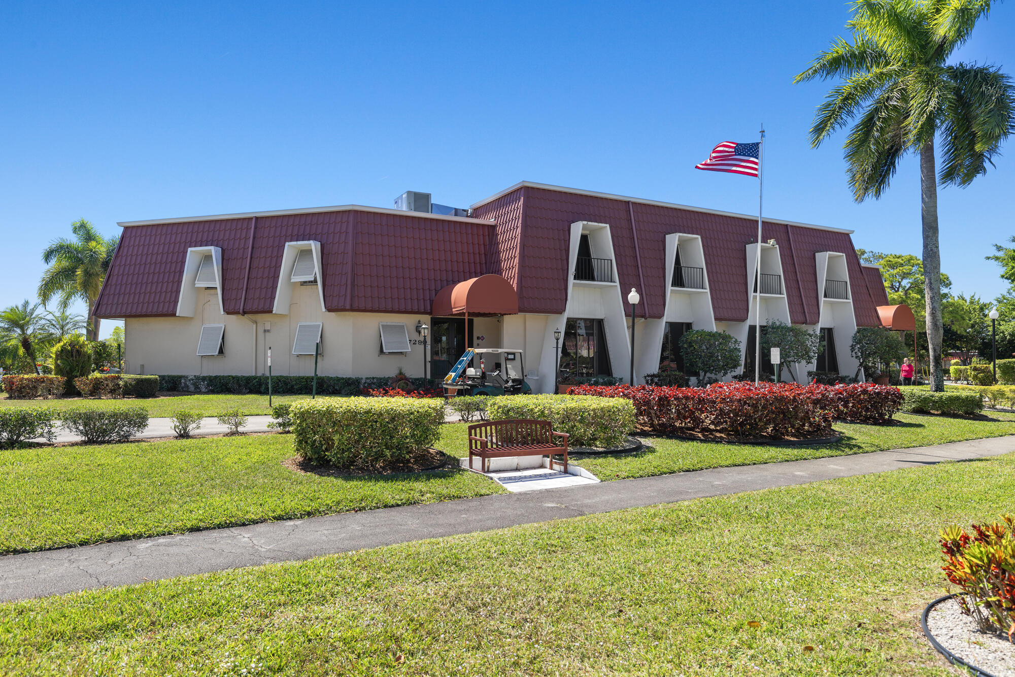 251 Down E Lane Lake Worth, FL 33467 - Photo 21 of 22 a front view of a house with a garden and yard
