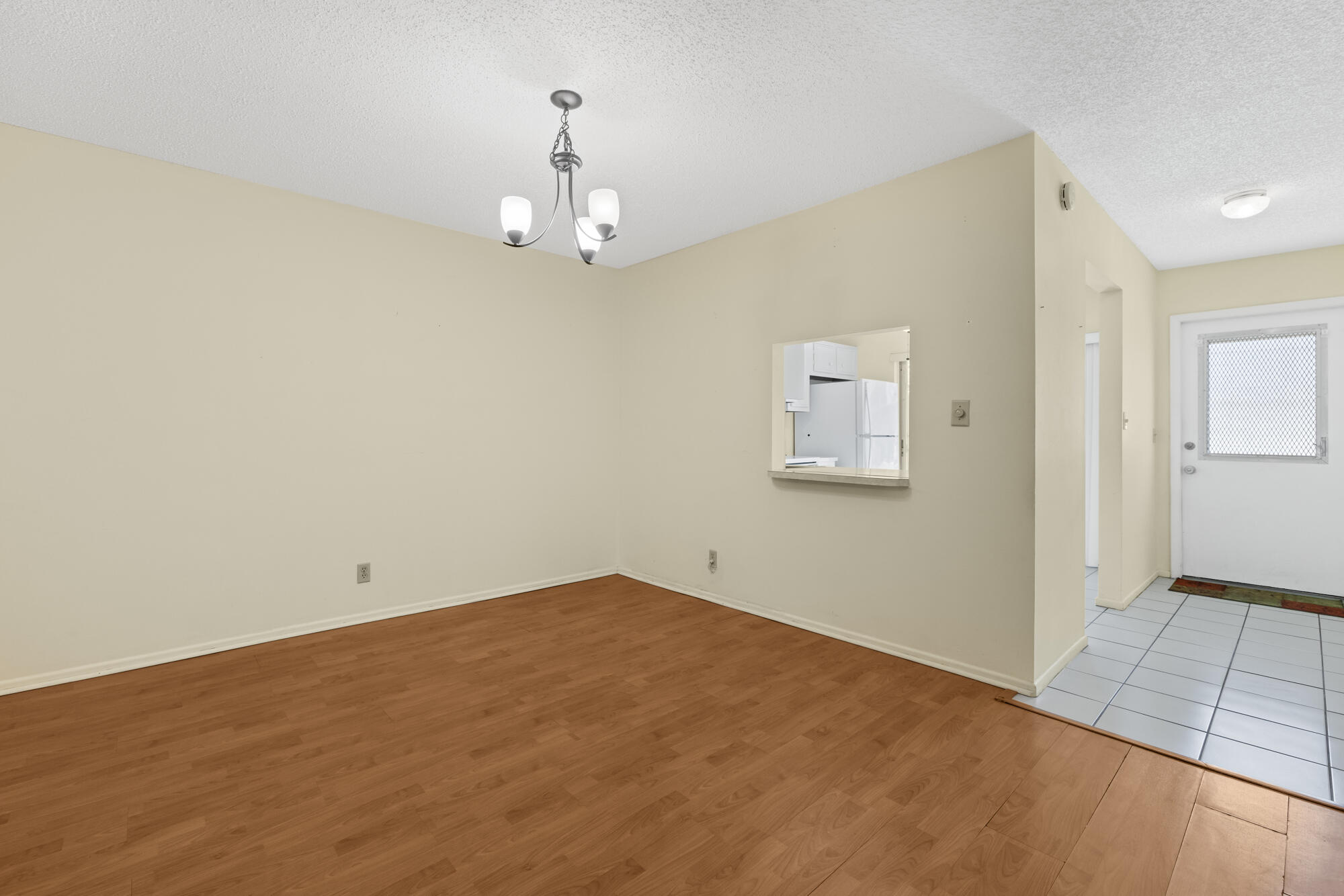 251 Down E Lane Lake Worth, FL 33467 - Photo 8 of 22 wooden floor in an empty room with a window