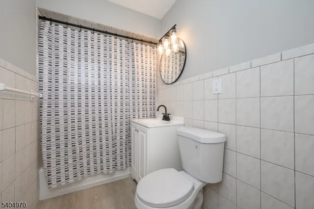 a white toilet sitting next to a bathroom sink