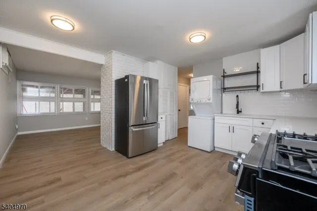 a kitchen with a refrigerator a stove and a sink