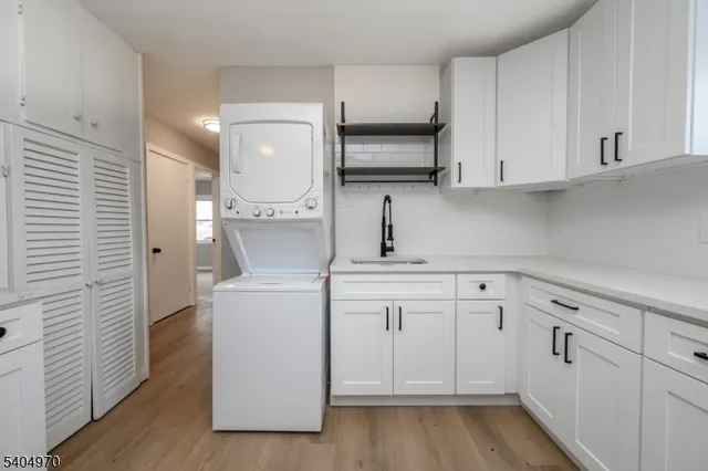 a kitchen with white cabinets and white appliances