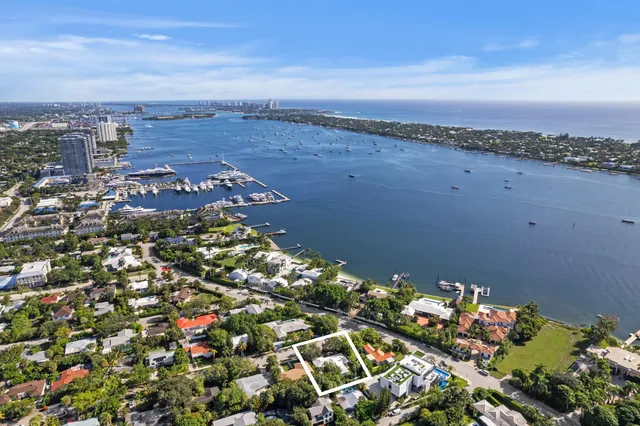a view of a house with a tree and wooden fence