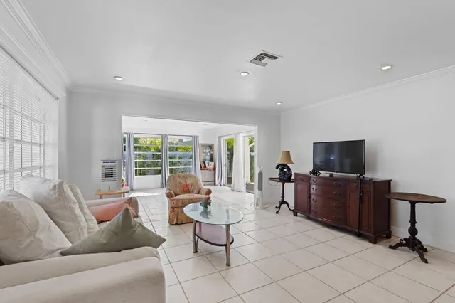 a living room with furniture and floor to ceiling windows
