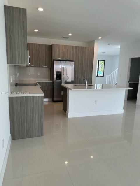 15814 Southwest 136 Way Miami, FL 33196 - Photo 6 of 33 a kitchen with a sink stainless steel appliances and cabinets