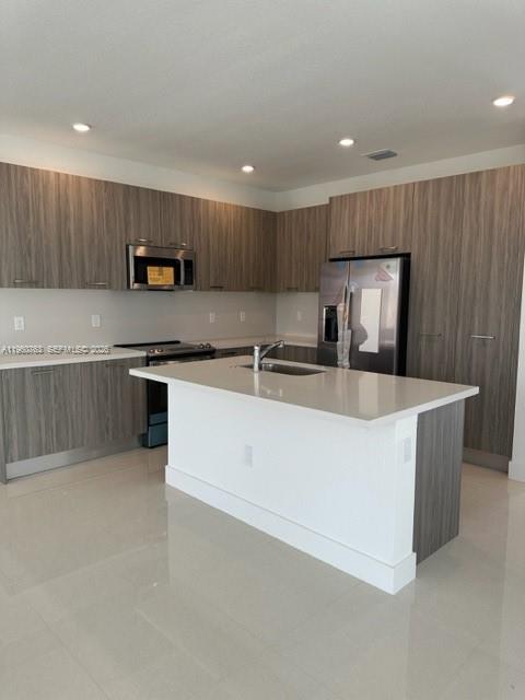 15814 Southwest 136 Way Miami, FL 33196 - Photo 7 of 33 a large kitchen with stainless steel appliances a sink a stove a microwave a refrigerator and cabinets