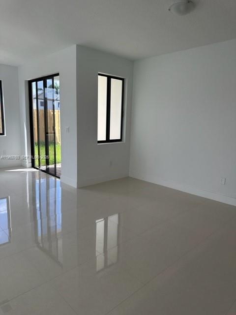 15814 Southwest 136 Way Miami, FL 33196 - Photo 8 of 33 a view of an empty room with glass door