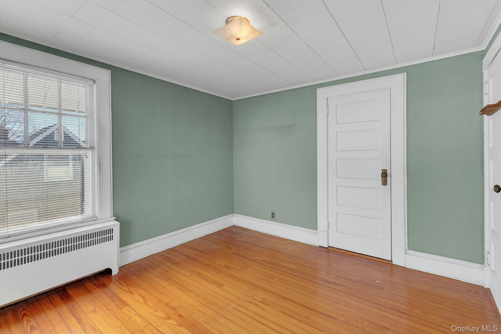 463 South 3rd Street Lindenhurst, NY 11757 - Photo 15 of 24 a view of empty room with wooden floor and fan