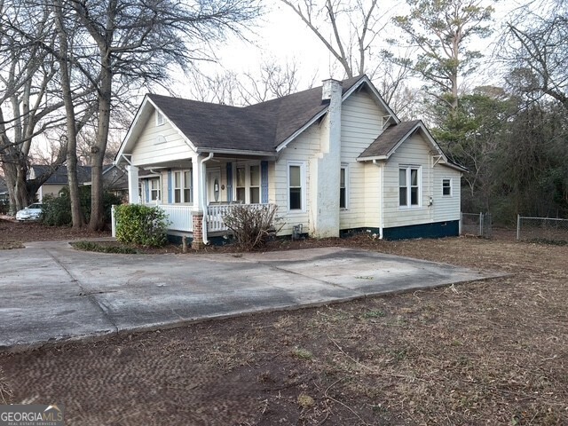 6 Derrick Avenue Hampton, GA 30228 - Photo 2 of 12 a view of a house with a yard and large trees