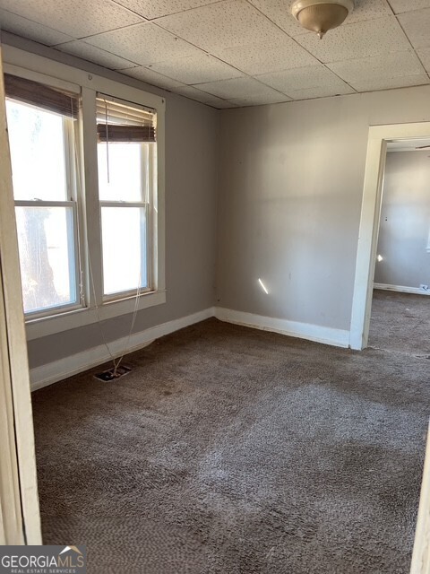 6 Derrick Avenue Hampton, GA 30228 - Photo 7 of 12 an empty room with a empty space and windows