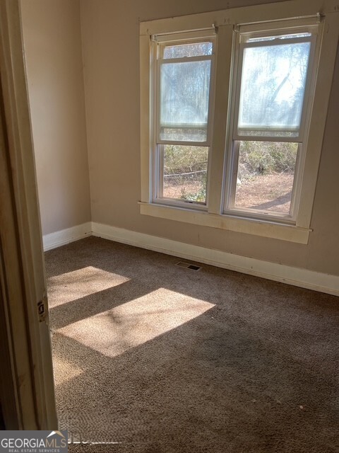 6 Derrick Avenue Hampton, GA 30228 - Photo 8 of 12 a view of empty room with window