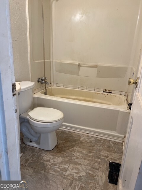 6 Derrick Avenue Hampton, GA 30228 - Photo 10 of 12 a bathroom with a toilet and a shower