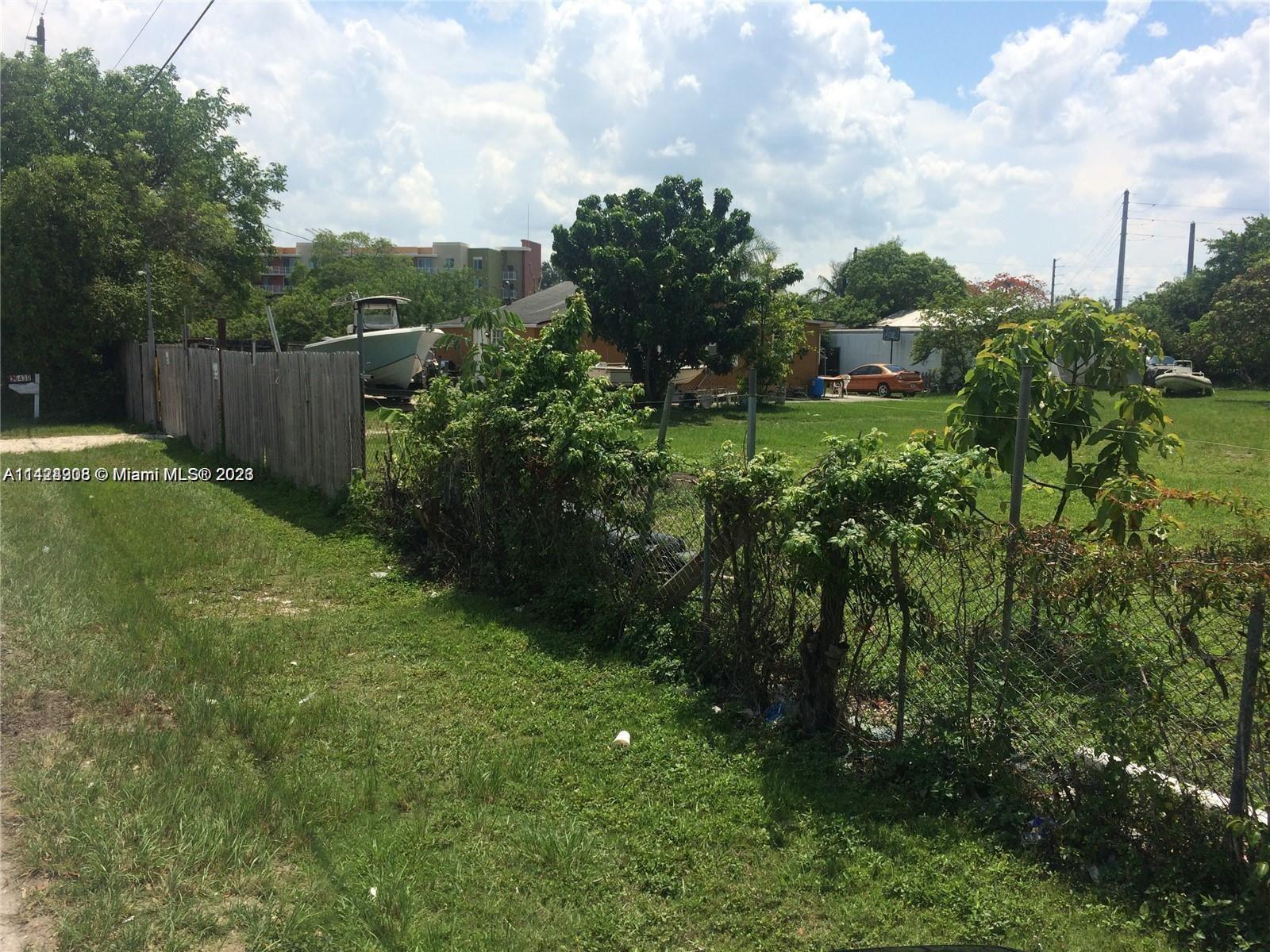 26430 Mable Street Homestead, FL 33032 - Photo 2 of 3 a view of a green yard with large trees