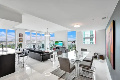 a living room with fireplace furniture and a large window