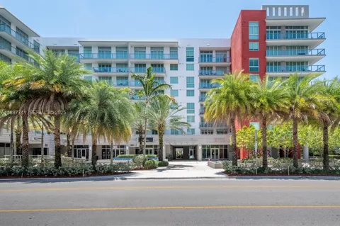 two palm trees in front of a building