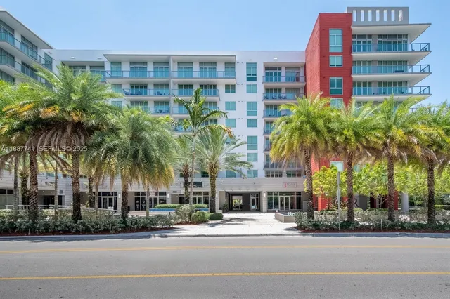two palm trees in front of a building
