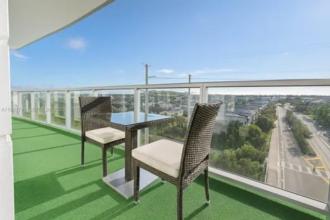 a balcony with a table and chairs