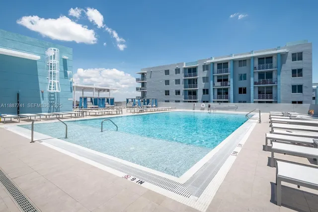 a view of a kitchen with kitchen island a faucet a chandelier and living room view