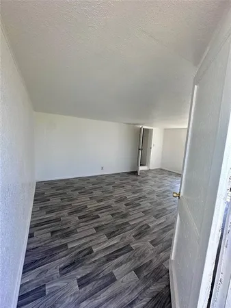 a view of a room with wooden floor