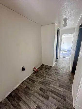 a view of a room with wooden floor and stairs
