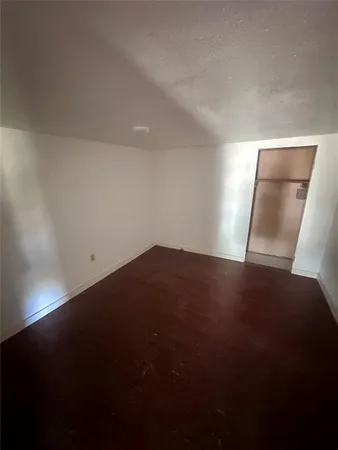 a view of room and hall with wooden floor