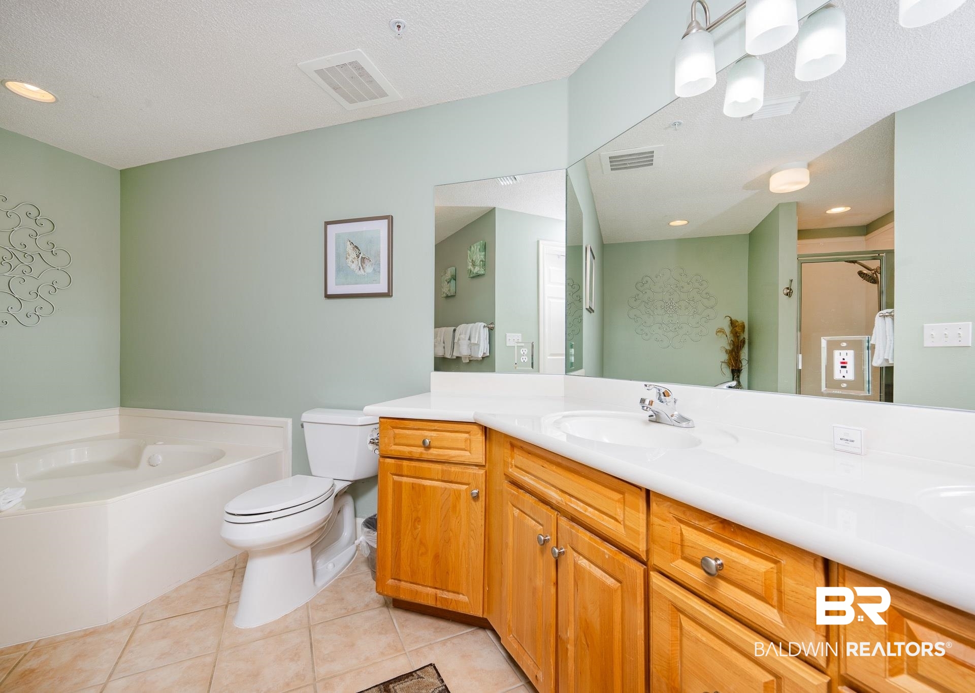27580 Canal Road, Unit 1429 Orange Beach, AL 36561 - Photo 11 of 45 Bathroom with double vanity, light tile patterned floors, a bath, a textured ceiling, and a shower stall