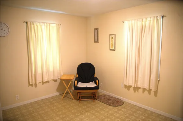 a living room with a chair and a window